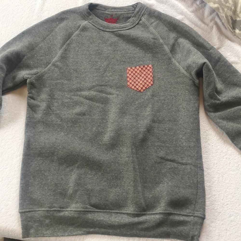 Gray sweatshirt with fox patterned pocket.